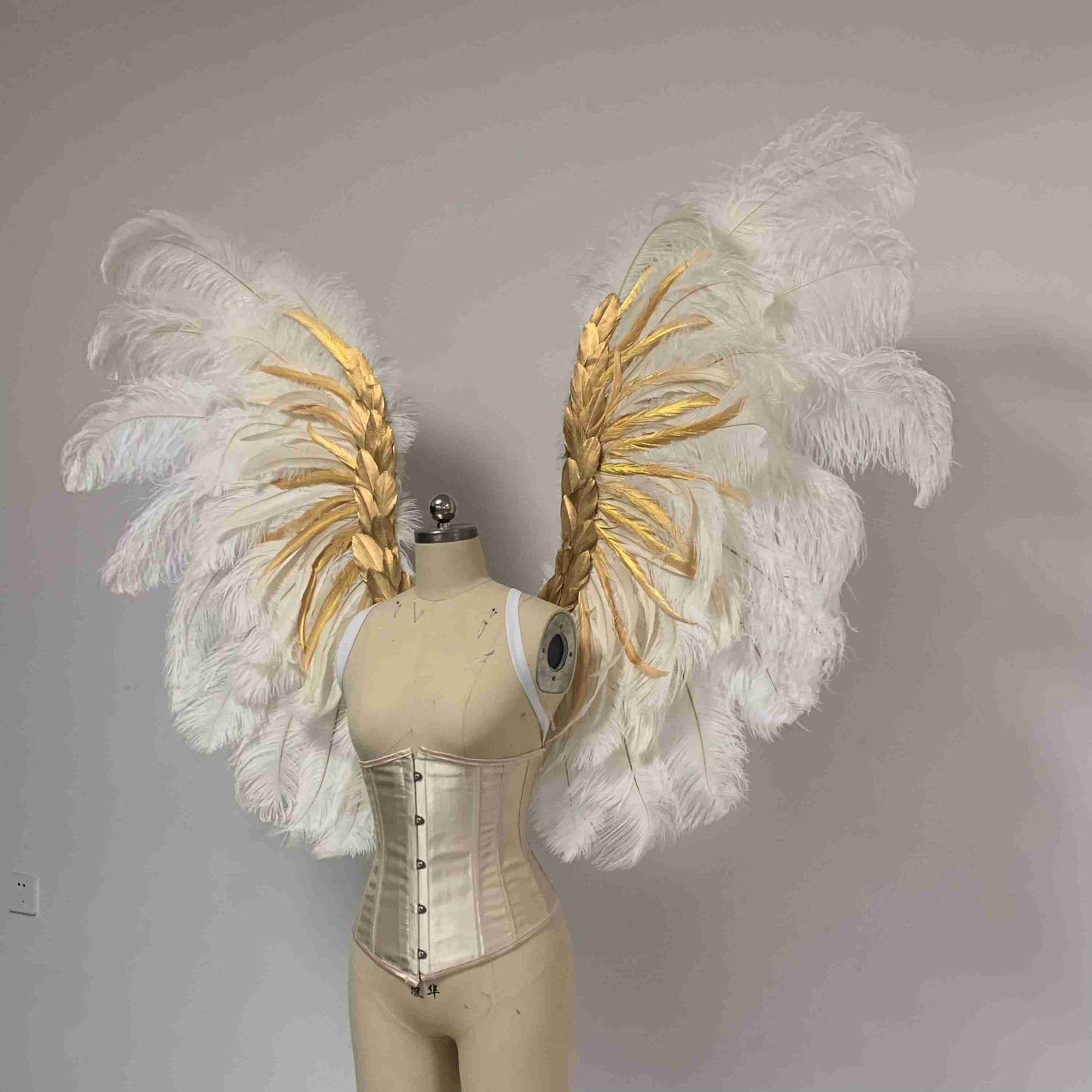 Our royal white angel wings from the left side. Made from ostrich feathers. Wings for angel costume. Suitable for boudoir photoshoots.