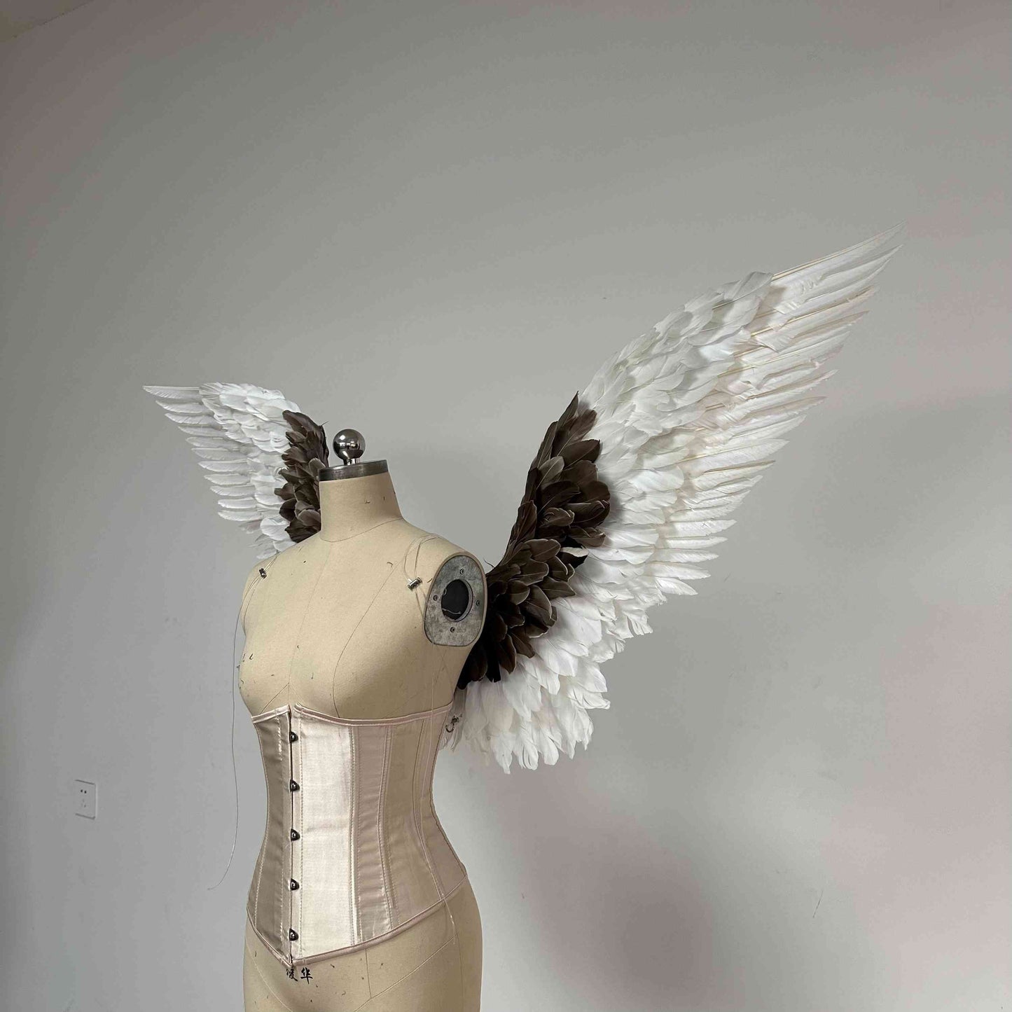 Our white gray angel wings from the left side. Made from goose feathers. Wings for angel wings costume. Suitable for photoshoots.