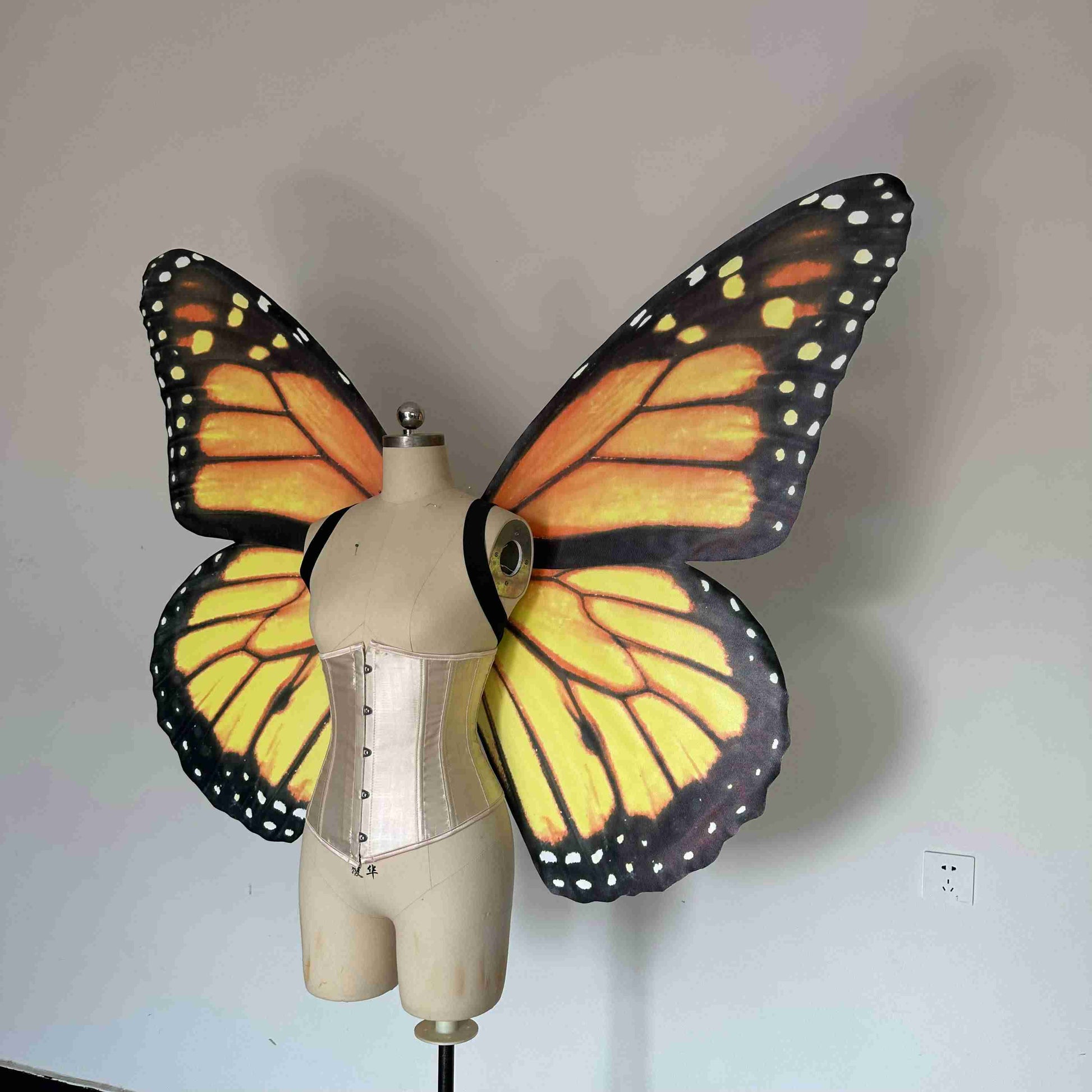 Our yellow black butterfly wings from the left side. Made from cloth. Can be also named fairy wings or pixie wings.